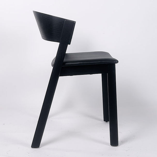 Side view of stackable plywood chair in natural woodgrain finish.