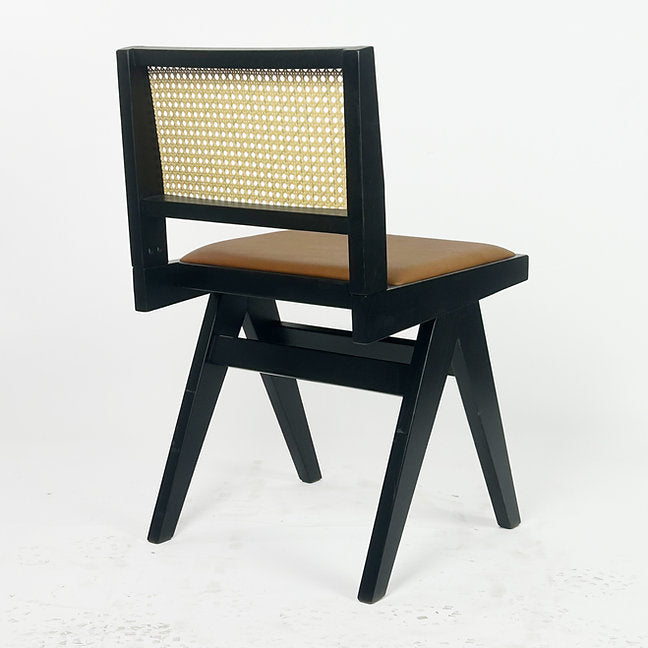Neutral-toned chair with curved rattan and clean-lined wood frame.