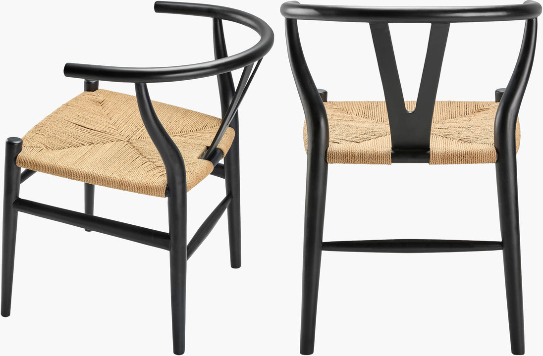 Black seagrass and teak dining chairs with mid-century modern shape, styled in a minimalist or contemporary dining space.
