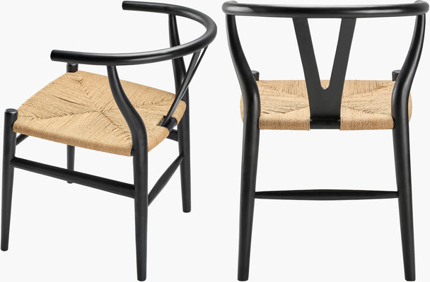 Black seagrass and teak dining chairs with mid-century modern shape, styled in a minimalist or contemporary dining space.