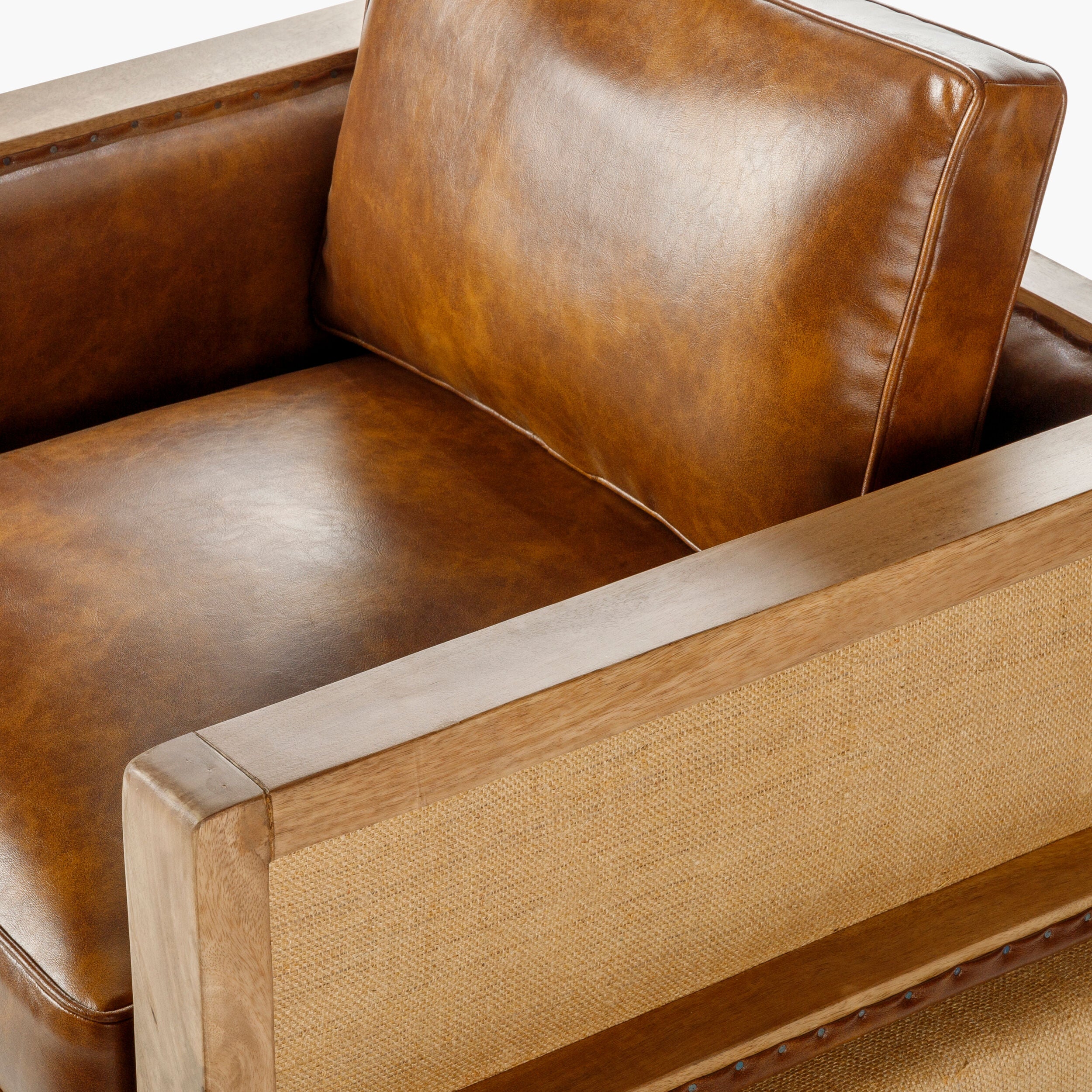Close-up of a modern leather armchair with wood trim - premium quality craftsmanship furniture from Room to Bloom INC.