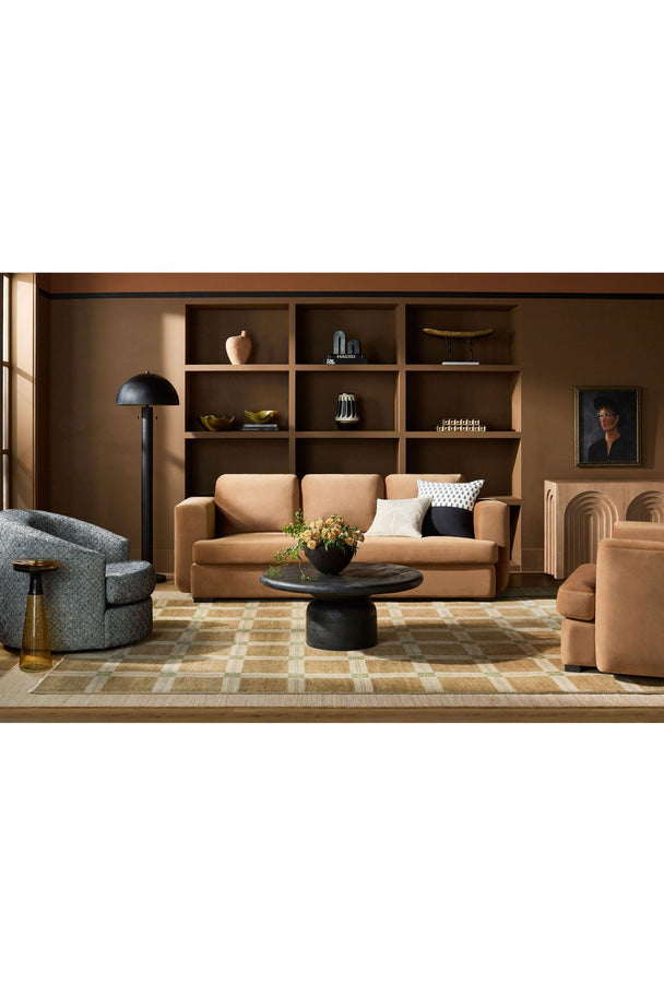 Modern living room with tan velvet sofa, built-in shelving, and geometric decor - curated modern furniture from Room to Bloom INC.