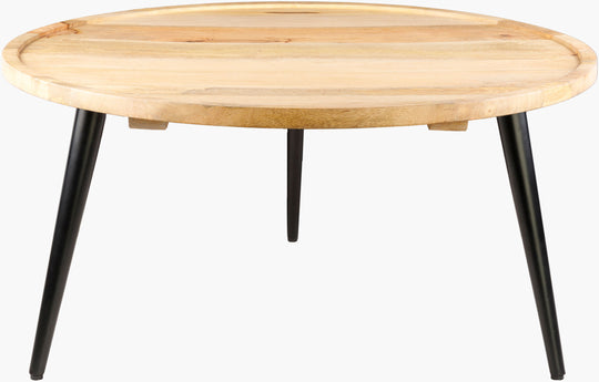 Round mango wood coffee table with matte black iron base in a modern living room.